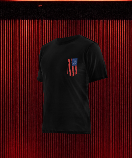 Front of Loaded Package tactical apparel with logo on chest and U.S. flag on sleeve — patriotic gear for veterans, military, and 2A supporters.