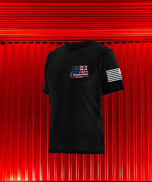 Front of Loaded Package shirt with chest logo and American flag on sleeve — tactical apparel for military, veterans, and patriots.