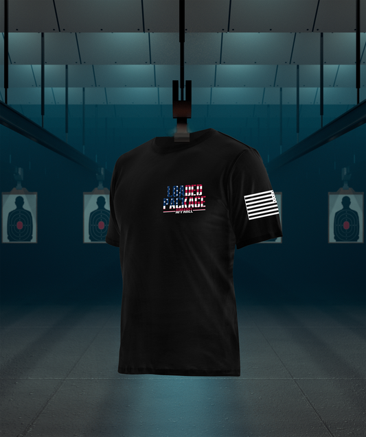 Front of Loaded Package tactical shirt with logo on chest and American flag on sleeve — patriotic gear for veterans, military, and pro-2A supporters.